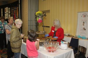 Chocolatier hands out chocolate samples to attendees